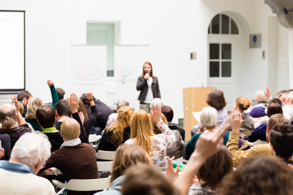 A lecturer in front of a crowd